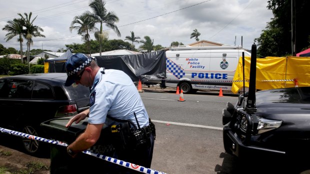 Police cordon off the area around the Manoora house where eight children died.