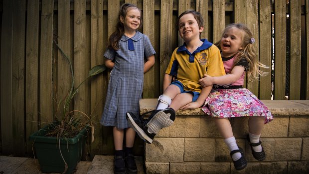 On a mission: Year 3 student Cormac Ryan with his sisters Tilly, 7, and Hannah, 3. 