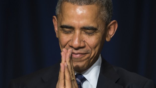Barack Obama bows his head towards the Dalai Lama at the National Prayer Breakfast in Washington.