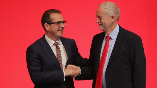 Jeremy Corbyn MP (right) shakes hands with Owen Smith MP as they arrive to hear the result for the new leader of the Labour Party.