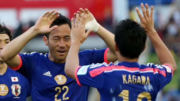 Flying start: Japan's Maya Yoshida (left) celebrates his goal with teammate Shinji Kagawa.