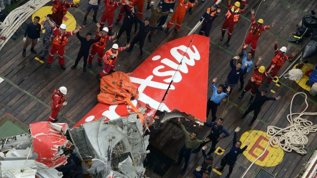 Indonesian search crews recover the tail of AirAsia QZ8501.