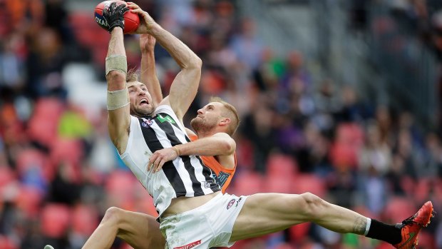 Back to form: Travis Cloke marks strongly over Giant Joel Patfull.