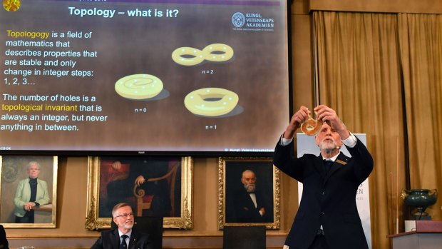 Professor Thors Hans Hansson gives a demonstration after revealing the winners of the Nobel prize in physics in Stockholm.