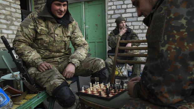 Fighters of the Azov Battalion play chess during a break in the town of Shyrokyne, eastern Ukraine.