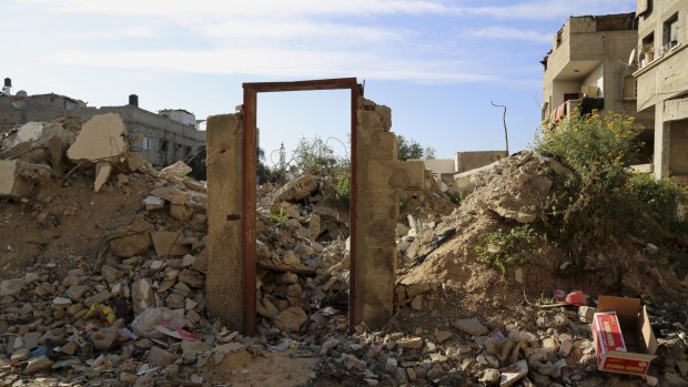 An empty frame doorway is seen on the rubble of a destroyed building that was damaged in the Israel-Hamas war.
