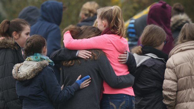 Pupils console each other at the Joseph-Koenig-Gymnasium high school on Wednesday.