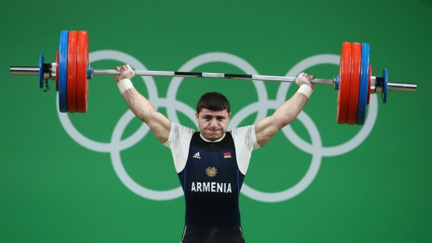 Andranik Karapetyan of Armenia lifts during the Men's 77kg competition.