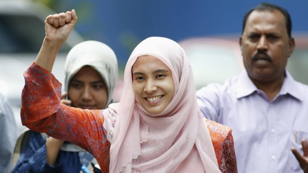Nurul Izzah raises her fist as she is released on bail from a police station in Kuala Lumpur on Tuesday.