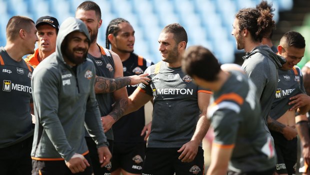 United: Robbie Farah shares a joke with teammates at Tigers training on Thursday.