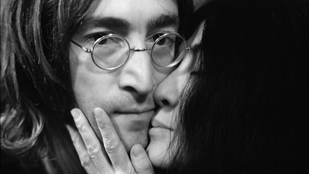 John Lennon and Yoko Ono kiss.