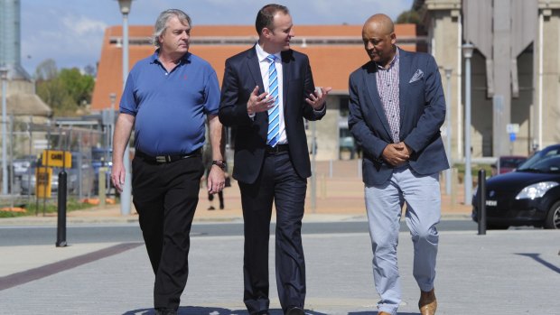 Signed up: Chief Minister Andrew Barr talks with future Uber drivers Gary Woodbridge and Teferi Gungl.
