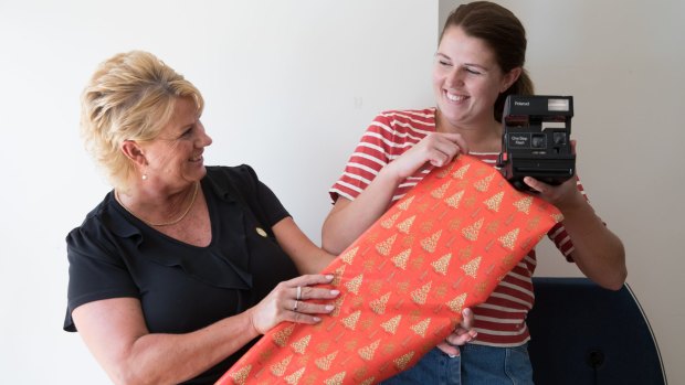 Kathryn Cameron with her daughter Rachael, is planning to give secondhand gifts this Christmas in Sydney. Rachael is holding a secondhand camera she once received. 