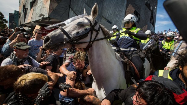 Protesters clash with Reclaim Australia protesters at Federation Square under a huge police presence. 