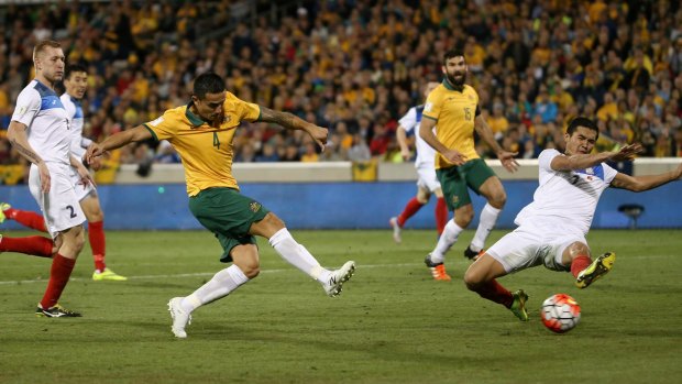 No mistake: Tim Cahill slots home Australia's second goal against Kyrgyzstan.