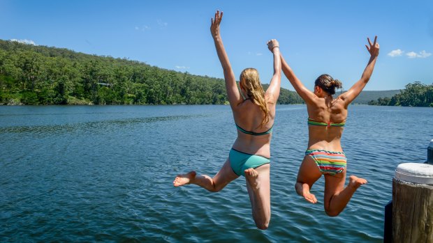 Girls jump into a secret swimming spot on the Shoalhaven River.