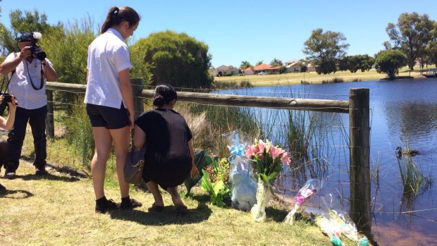 Flowers laid out by a Landsdale lake in tribute to Sam Trott.