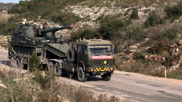 A Turkish army truck loaded with a self-propelled gun heads to the Syrian border near Yayladagi on Wednesday. 
