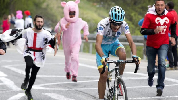 Astana's Italian rider Fabio Aru is cheered up the mountain by local fans on his way to winning stage 20 of the Giro d'Italia on Saturday.