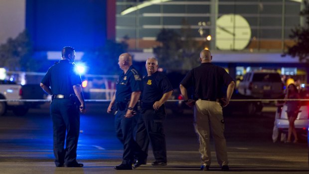 Police stand outside the cinema where a 'drifter' opened fire during a filming of <i>Trainwreck</i> in Lafayette, Louisiana.