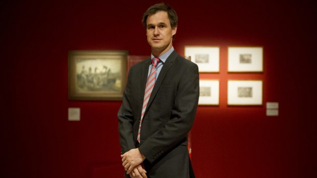 Curator of art at the Australian War Memorial, Warwick Heywood, stands in the special exhibitions gallery where <i>Reality in flames</i> is being shown.