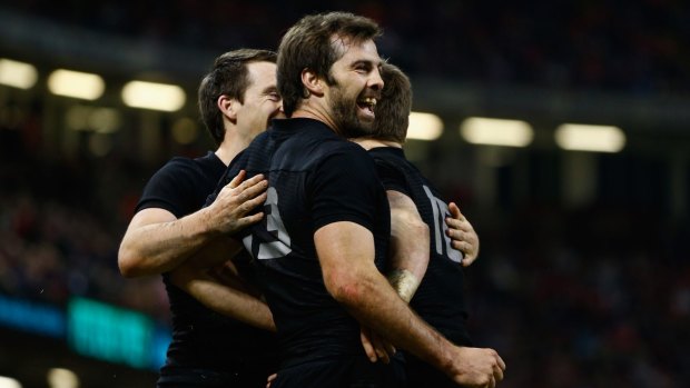 'Cuddlegate': Conrad Smith and Beauden Barrett share a celebratory hug during the All Blacks v Wales game ... little did they know they would be in for a few more.