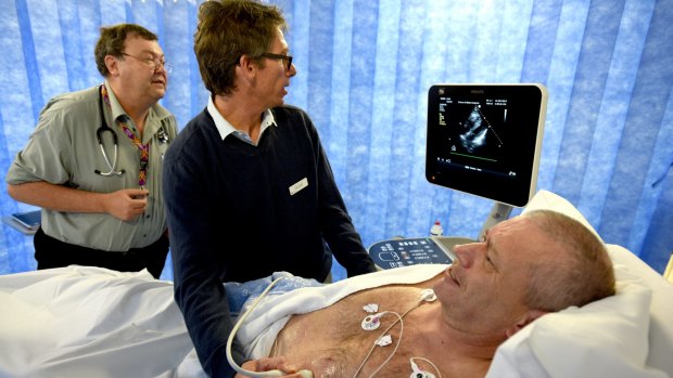 Emergency physicians Bruce Way and Matt Davis check a POCUS scan as they assess the heart of patient David McLean.