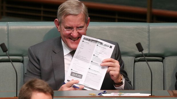 Former Liberal minister Ian Macfarlane holds up an ALP membership form, sent to him during Question Time on Thursday.
