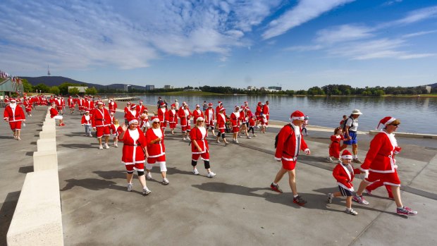 Crowds of Santas will don red suits and walk or run around the Lake for the 2014 Santa Fun Run.