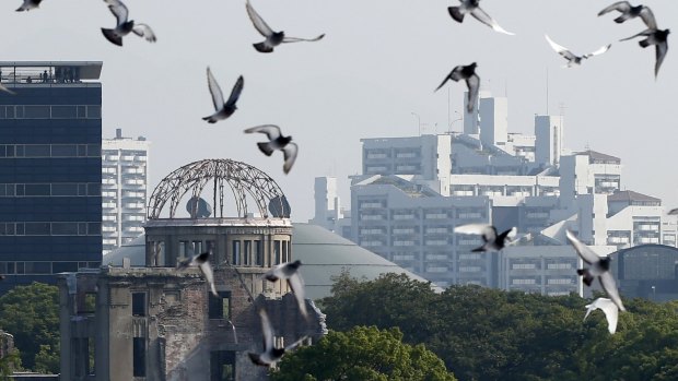 Doves fly over the Peace Memorial Park near the Atomic Bomb Dome at a ceremony in Hiroshima on Thursday. 
