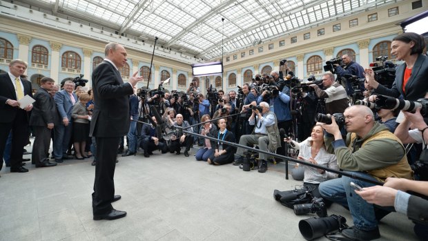 Mr Putin speaks to the media after his call-in TV show in Moscow.