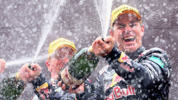 Craig Lowndes and Steven Richards celebrate on the podium after winning the Bathurst 1000.