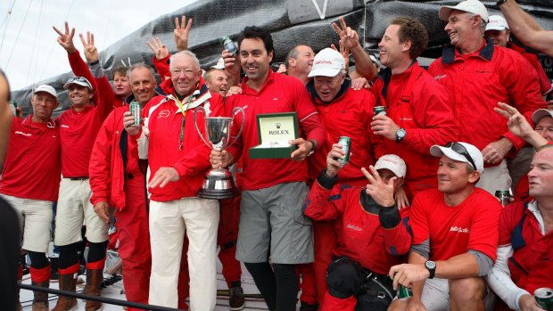 The captain of supermaxi Wild Oats XI Mark Richards (centre with trophy), celebrates with owner Bob Oatley and the Sydney-to-Hobart crew in 2007.