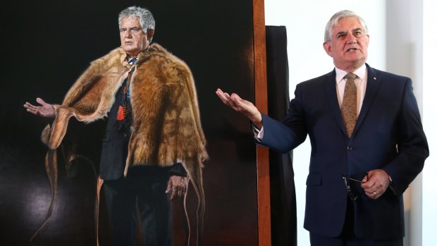 Ken Wyatt, the first indigenous MP in the House of Representatives, with his portrait by artist Mary Moore at Parliament House.