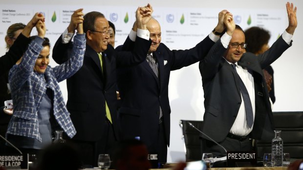 United Nations climate change chief Christiana Figueres, left, UN Secretary-General Ban Ki-moon, French Foreign Affairs Minister and UN Climate Change Conference in Paris president Laurent Fabius and French President Franois Hollande celebrate an agreement on climate change on Sunday, December 13.