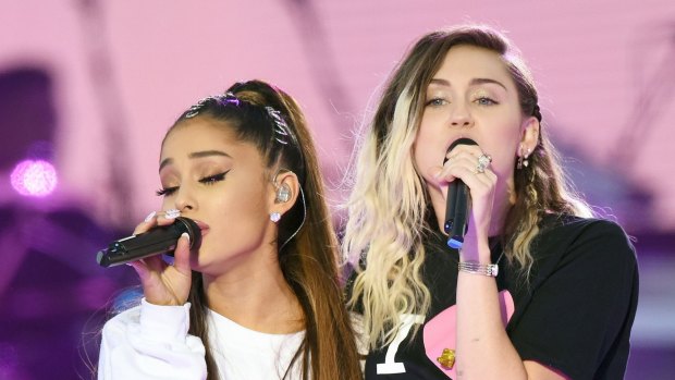 Ariana Grande, left, and Miley Cyrus perform at the One Love Manchester tribute concert in Manchester, England, Sunday, June 4, 2017.