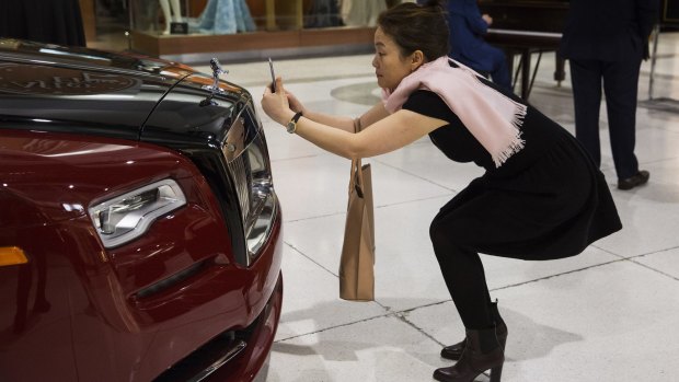 Guests look at Rolls Royces at a private reception at the Oakridge Centre in Vancouver. 