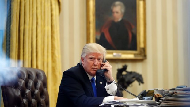 President Donald Trump speaks on the phone with Prime Minister of Australia Malcolm Turnbull in the Oval Office of the White House.