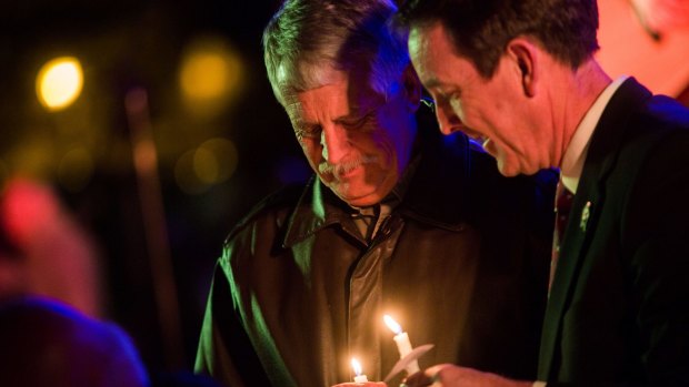 Critical of US ransom policy ... Carl Mueller holds his candle during a candlelight memorial honouring his daughter aid worker Kayla Mueller at the Prescott's Courthouse Square in Prescott, Arizona.