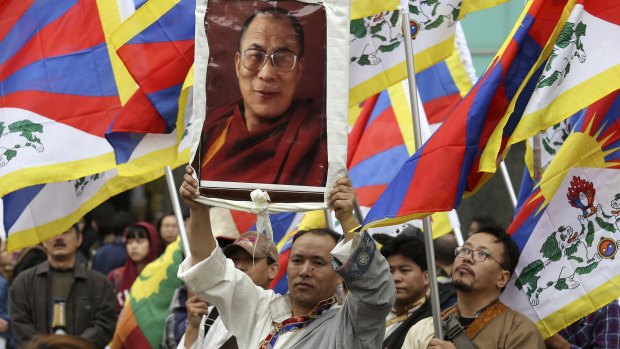 Activists with a poster of the Dalai Lama take part in a rally to support Tibet in Taipei on Sunday.