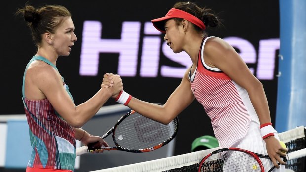Zhang Shuai, right, is congratulated by Simona Halep after their first round match.