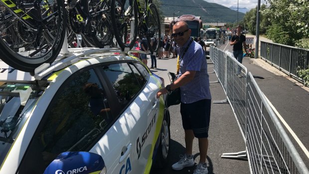 On tour: Eddie Jones gets into the Orica-Scott team car at the Tour de France.