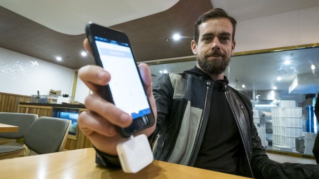 Square founder Jack Dorsey demonstrates the company's reader, which is set to get a final tick of approval from global credit card companies. 