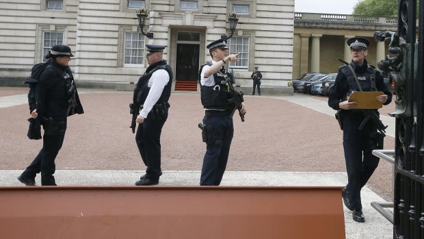 Increased security: Armed police officers work at the main gate of Buckingham Palace in London.