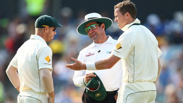 David Warner and Peter Siddle with umpire Aleem Dar during the second Test. 
