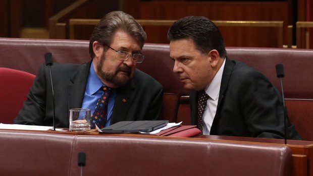 Senators Derryn Hinch and Nick Xenophon as midnight approaches in the Senate at Parliament House in Canberra on Tuesday.