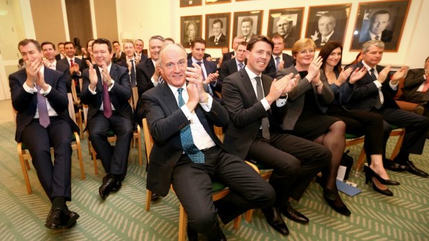 Coalition MPs applaud during a meeting at Parliament House on Monday.
