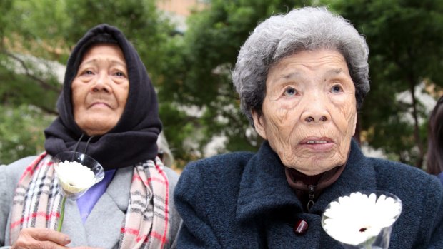 Former Philipine comfort woman, Estelita B. Dy (L), and former Taiwan comfort woman, Cheng Chen-tao, commemorating deceased comfort women outside Japan's representative office in Taipei, Taiwan.