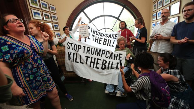 Protesters  gather inside the office of Republican Ohio senator Rob Portman on Monday.