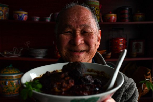 Peranakan Place owner Sam Wong with his dish ayam bush keluak (chicken braised with keluak nuts).